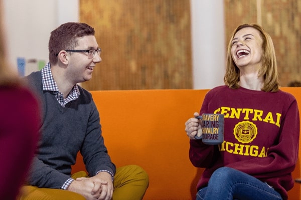 Students laughing and enjoying coffee.