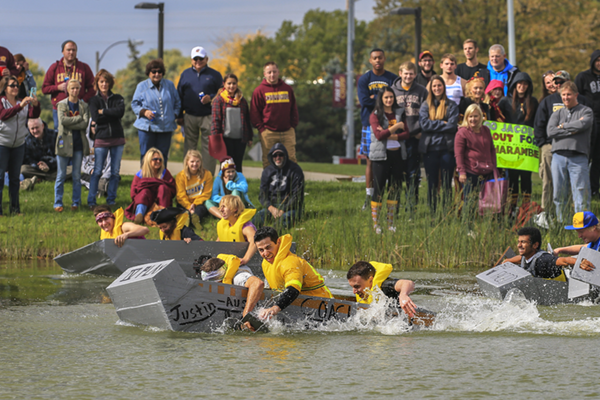 Students competing in the annual Cardboard Boat Race during Homecoming.