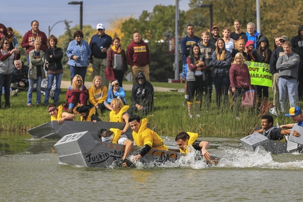 Students competing in the annual Cardboard Boat Race during Homecoming.