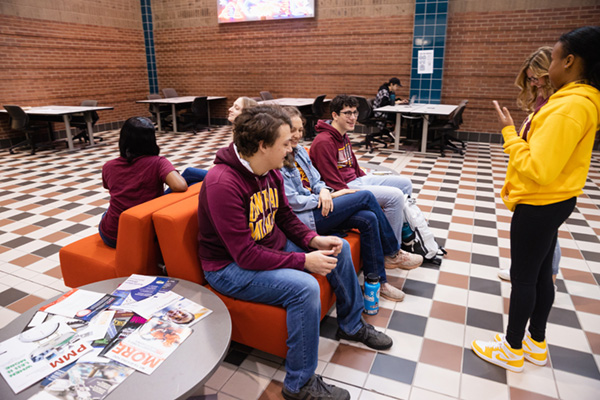 A group of students having a discussion in the lobby area of the Engineering and Technology building at CMU.