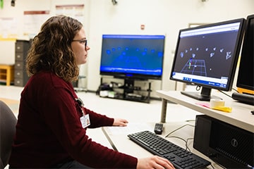 Brooke Ray sits in front of a computer to analyze motion data.