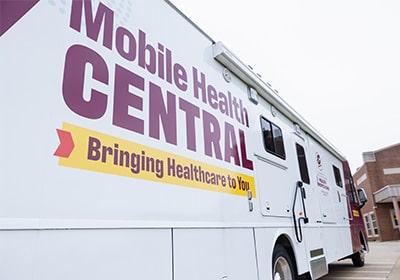 The Mobile Health Central bus parked near the College of Health Professions.
