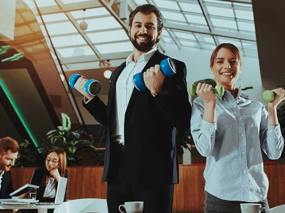 Two people holding dumbbells