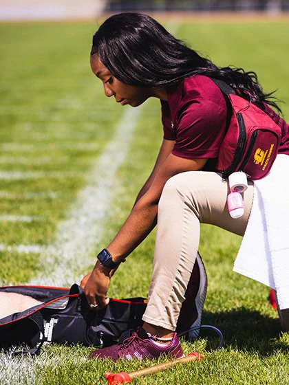 athletic trainer on football field