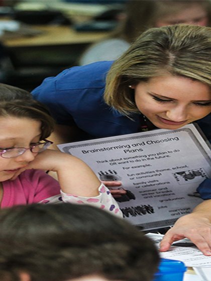 Teacher helping student