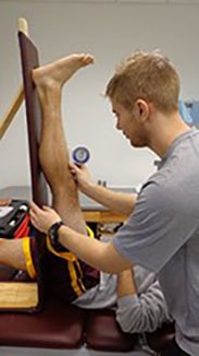 Student measuring leg flexibility