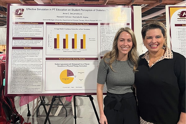 Dr. Rochelle Kopka and a physical therapy student pose in front of their research poster at a conference.