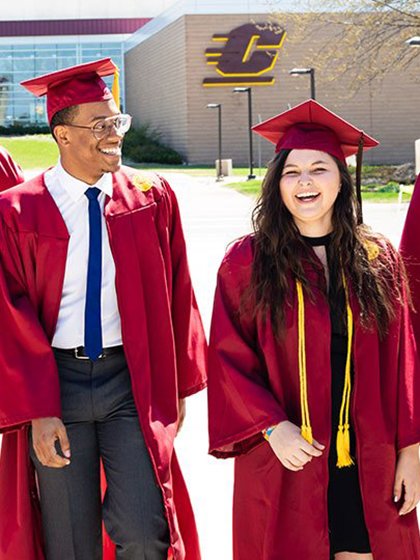 Happy CMU graduates outside in their caps and gown