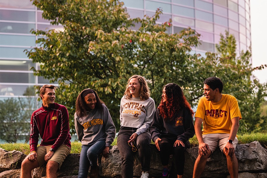 Students sitting in front of library