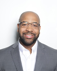 a man in a suit and glasses