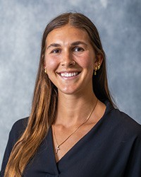20250618_CMU_staffportrait_Anderson_Alina009_200x250 a woman wearing a black blouse poses for a professional portrait