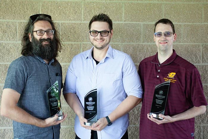 Shaun Holmes, Chris Zamplas, and James York pose with their 2023 Standing Ovation Awards.