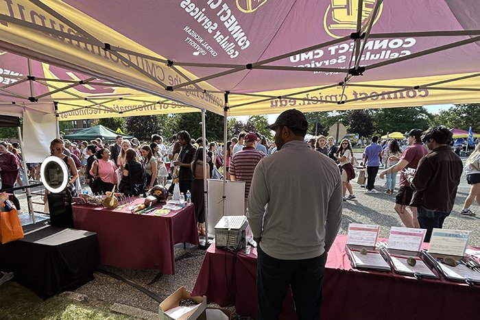 A view from the back of the tent toward the street full of students.