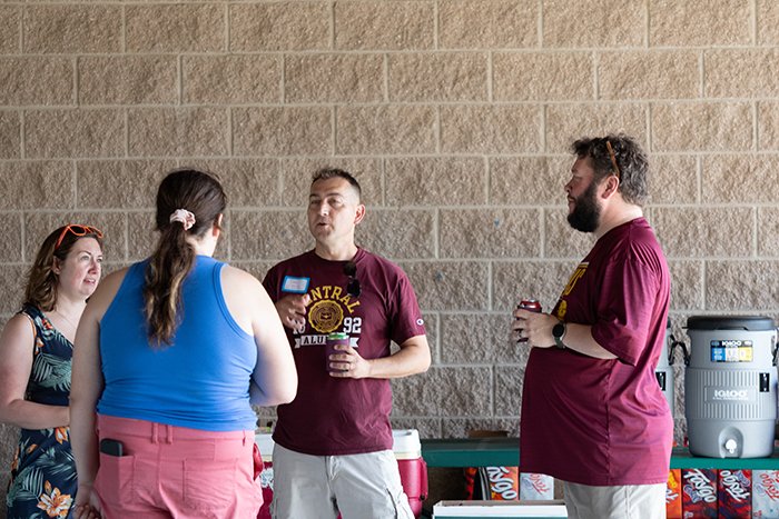 Four colleagues talk in a small group.