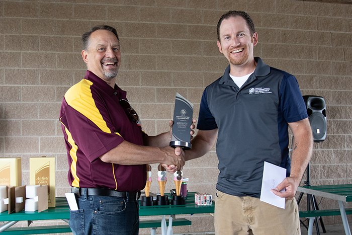 Jim Bujaki presents a Standing Ovation Award to Derek Leib.
