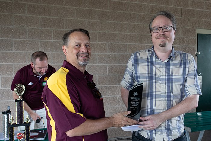 Jim Bujaki presents a Standing Ovation Award to Greg Hanley.