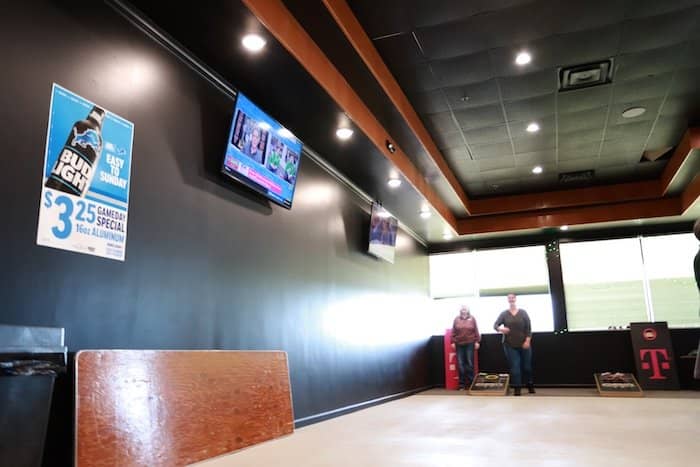 Two OIT staff members wait to throw cornhole bags.
