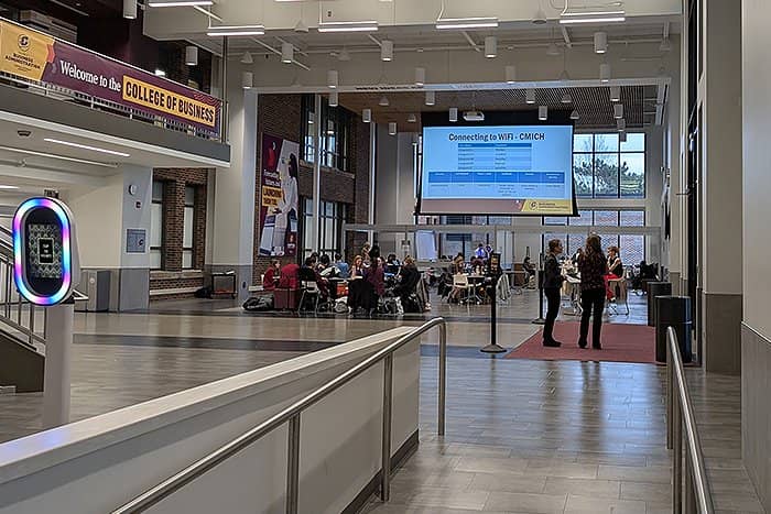 Wide angle photo of Grawn Hall atrium during the 2024 Business Professionals of America day. Participants are seated and standing.