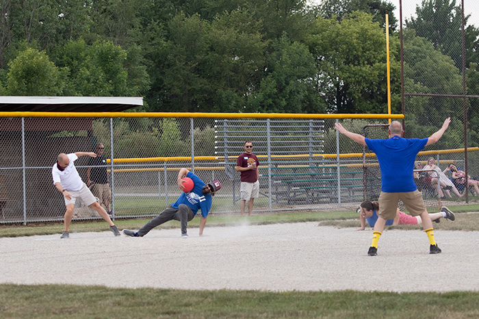 The first base player and runner meet at the bag.