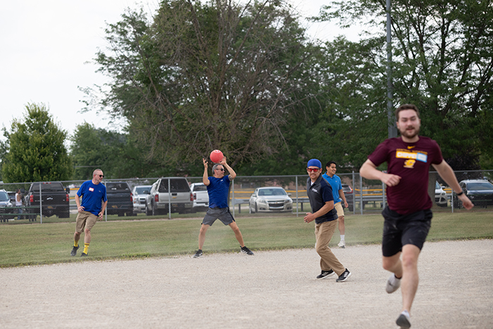 Players scurry around the field during play.