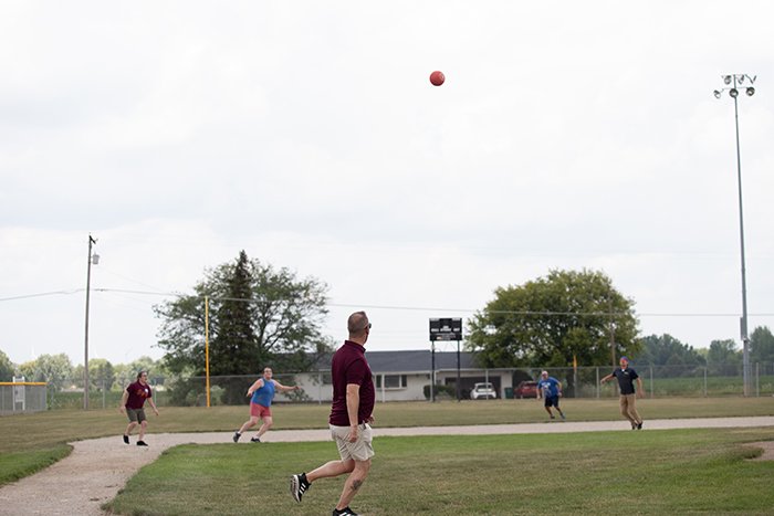 The kicker watches his ball fall into the arms of a defender.
