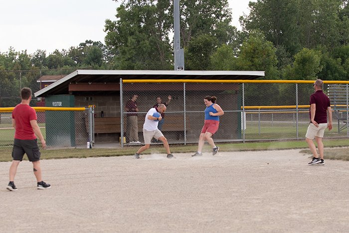 The first basemen attempts to beat a runner to the bag.