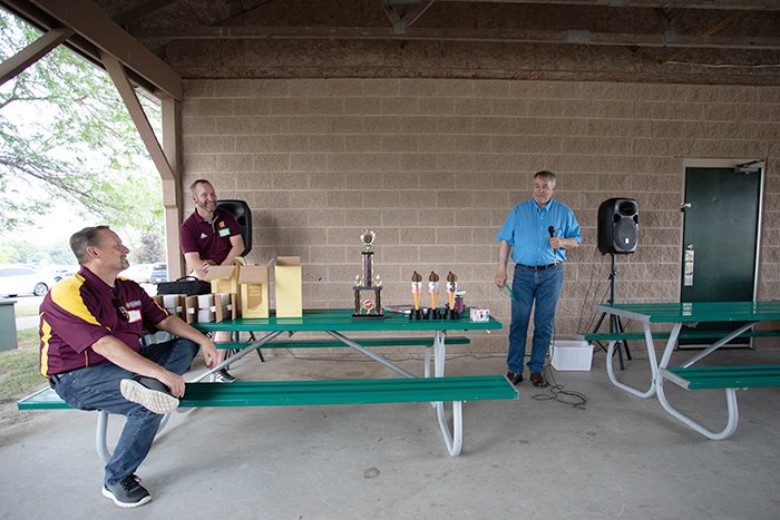 Mark addresses Jim while Brian looks on.
