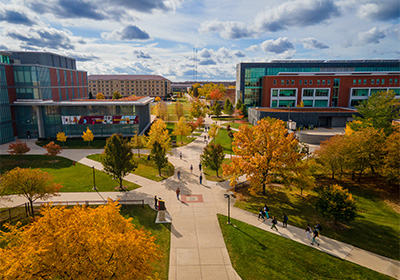Drone view of students walking between academic buildings on campus