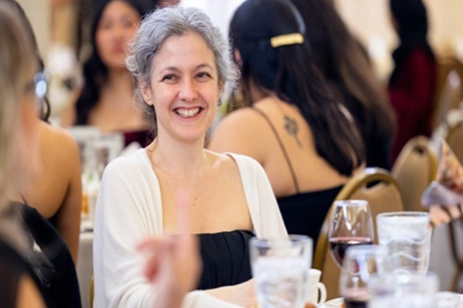 Dr. Wiline Pangle smiling, wearing a black top with a white over shirt.