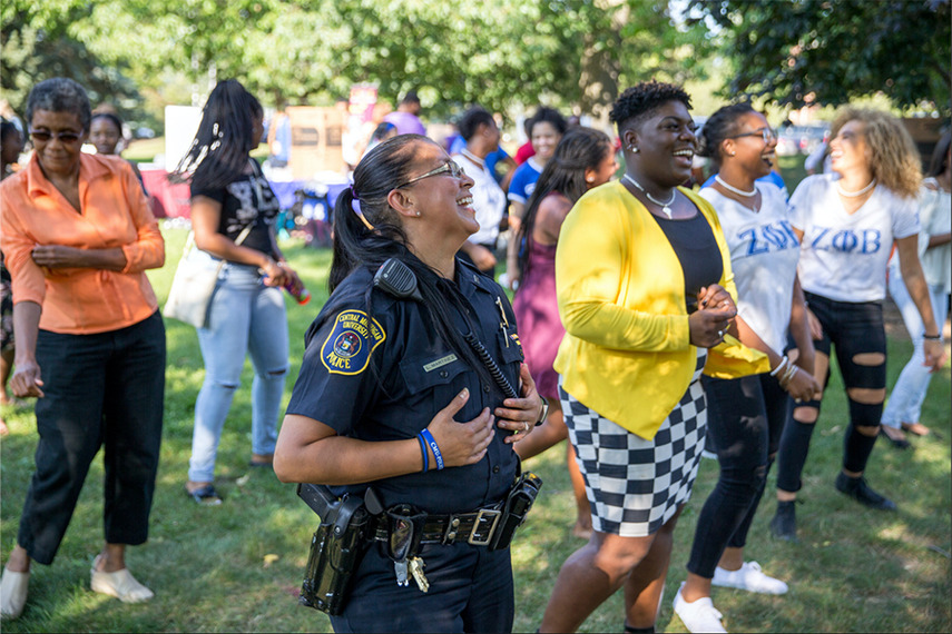 Image of CMU's Officer Martinez smiling and dancing at an On-Campus event