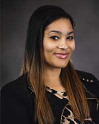 Professional headshot of Dr. Shawna Patterson-Stephens in dark attire against a gray background..