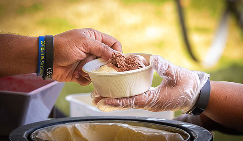 a person holding a bowl of ice cream