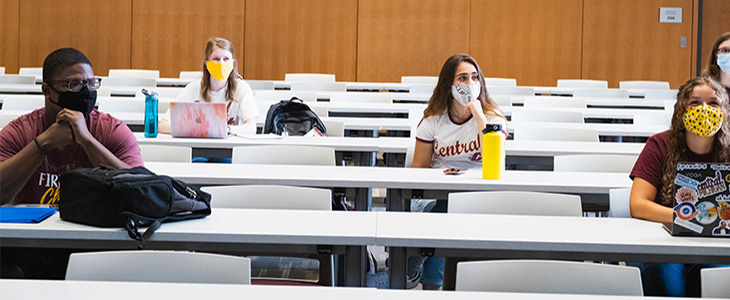 Photo with students wearing masks and social distancing