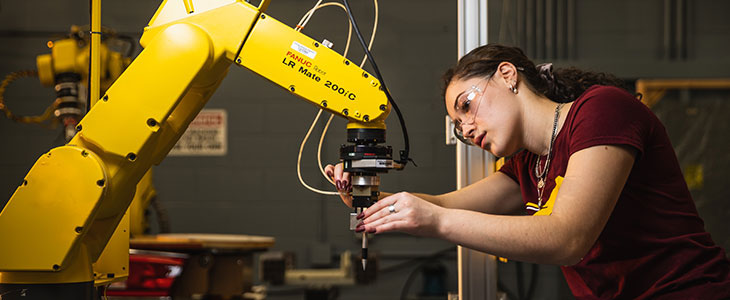 CMU student working with robot