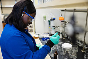 Female student works at a lab station in the Biosciences Building on the Central Michigan University campus.