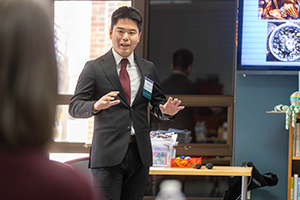 A man in a student talks to a person off screen about a business pitch