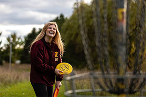 Woman playing disc golf in the park