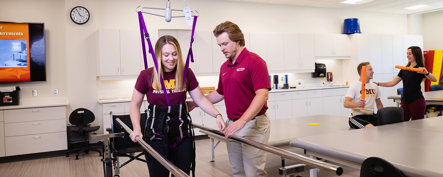 Two physical therapy students demonstrate techniques and exercises.