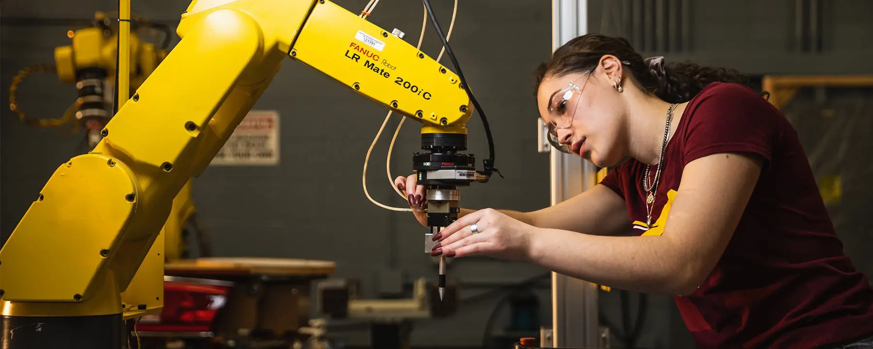 Engineering student working on a machine
