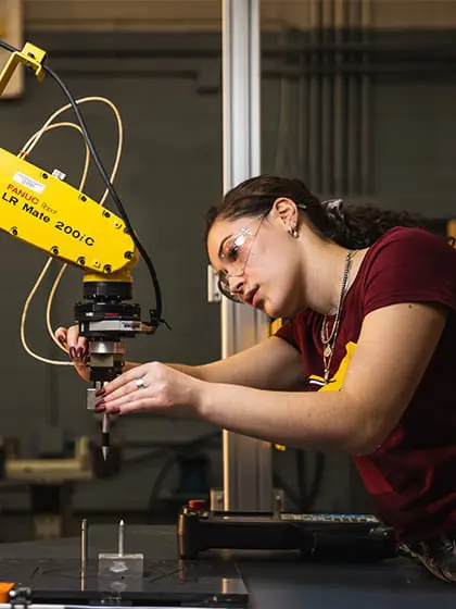 Engineering student working on a machine