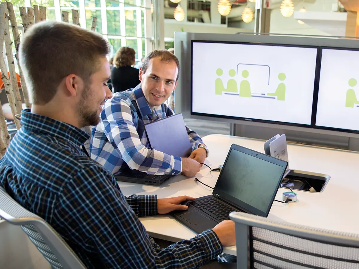 Two students work around a table in the College of Business Administration.