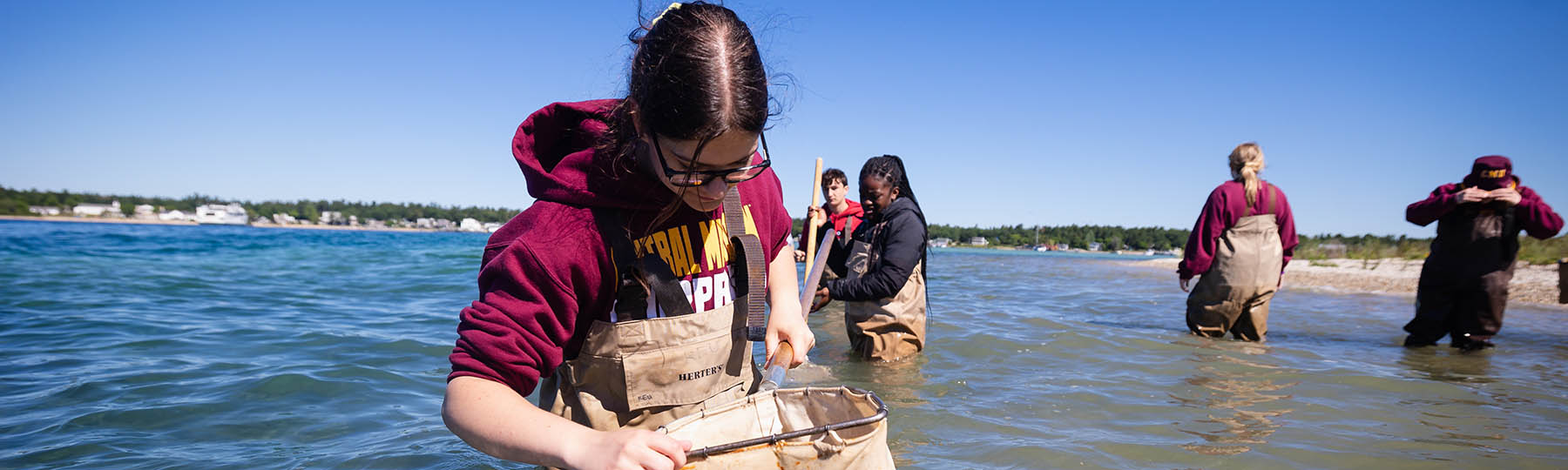 CMU biology students use nets to collect specimens from Lake Michigan.