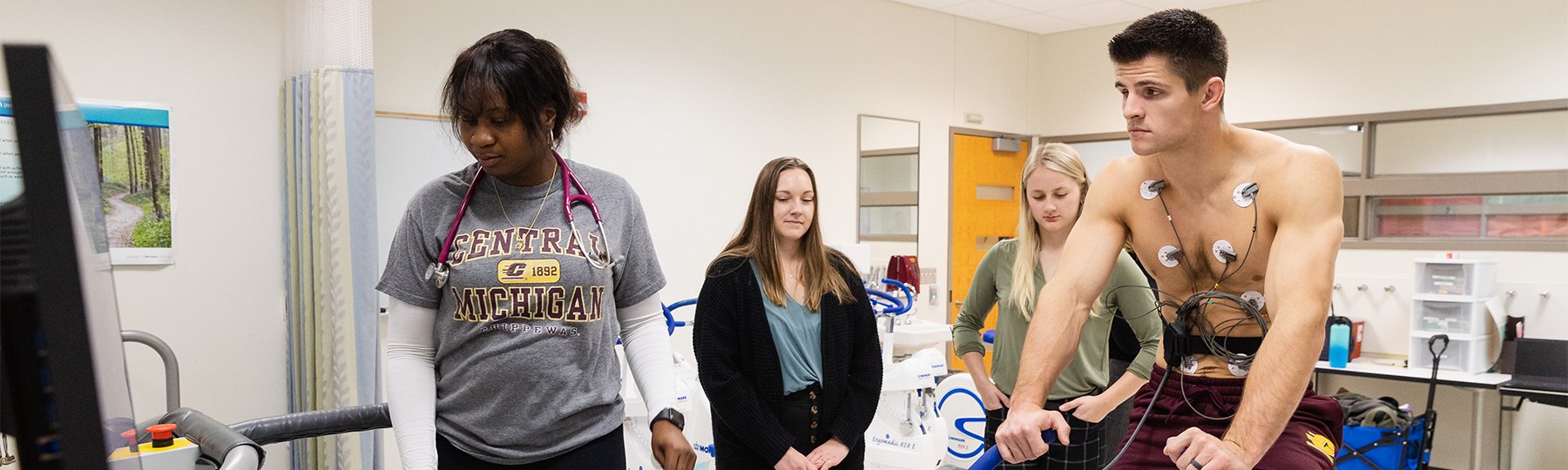 A group of exercise science students take measurements in a lab.