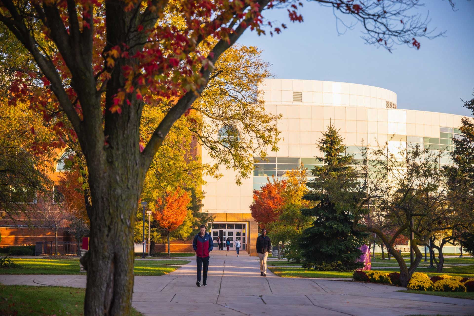 Students walking on campus in fall