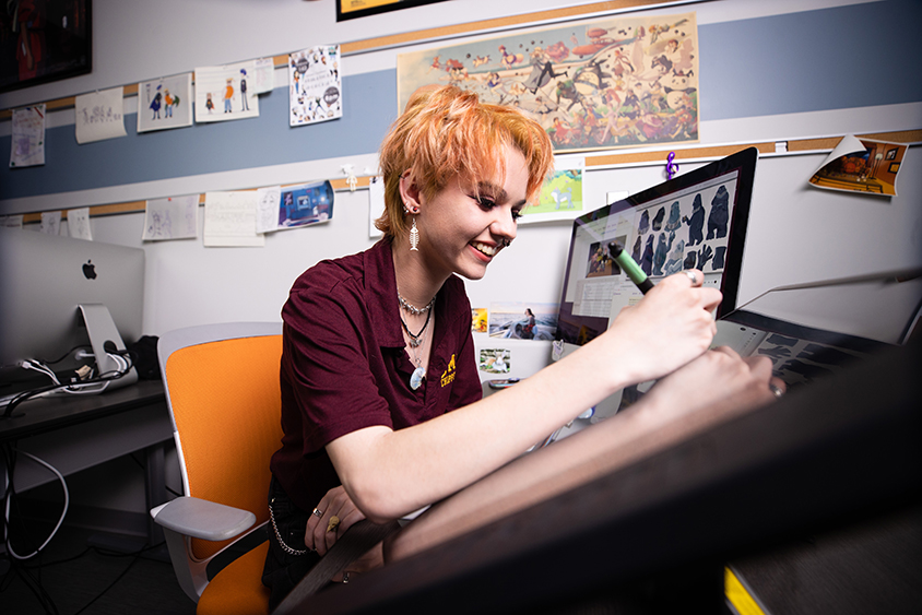 Female student drawing animations on a computer screen.