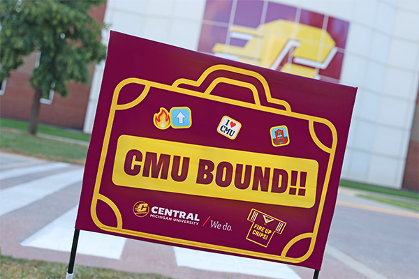 A CMU sign is staked in the ground. The sign says 