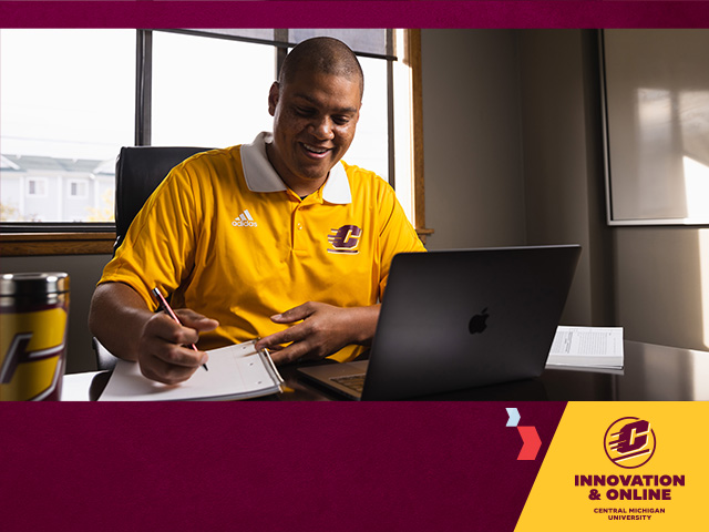 Male student with short dark hair wearing a gold short sleeve polo writes on a notepad and a laptop sits to the right. The CMU Innovation and Online logo sits in the lower right corner, with chevrons pointing to it, on a maroon background.