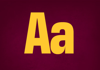 Font use example, a gold uppercase letter "A" followed by a lowercase letter "a" sits center, placed on a dark maroon background.
