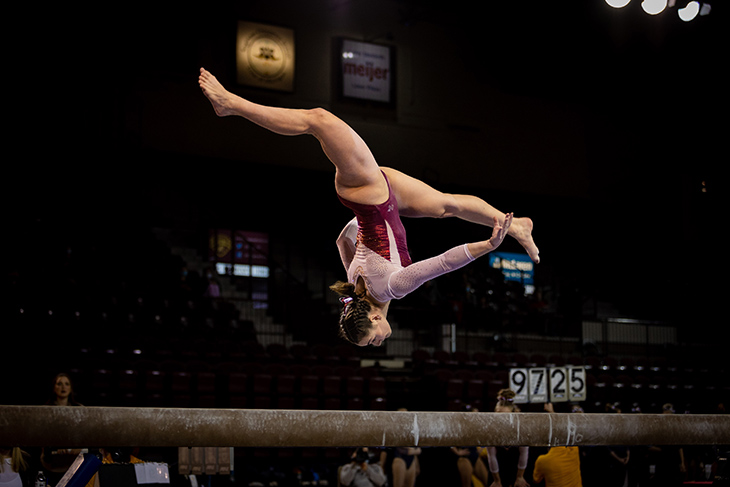 A member of the CMU Gymnastics performs their routine on the balance beam.