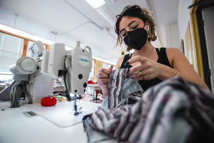 Fashion Merchandising & Design student Gabriela Salais works to finish up her designs for this year’s Threads Fashion Show.